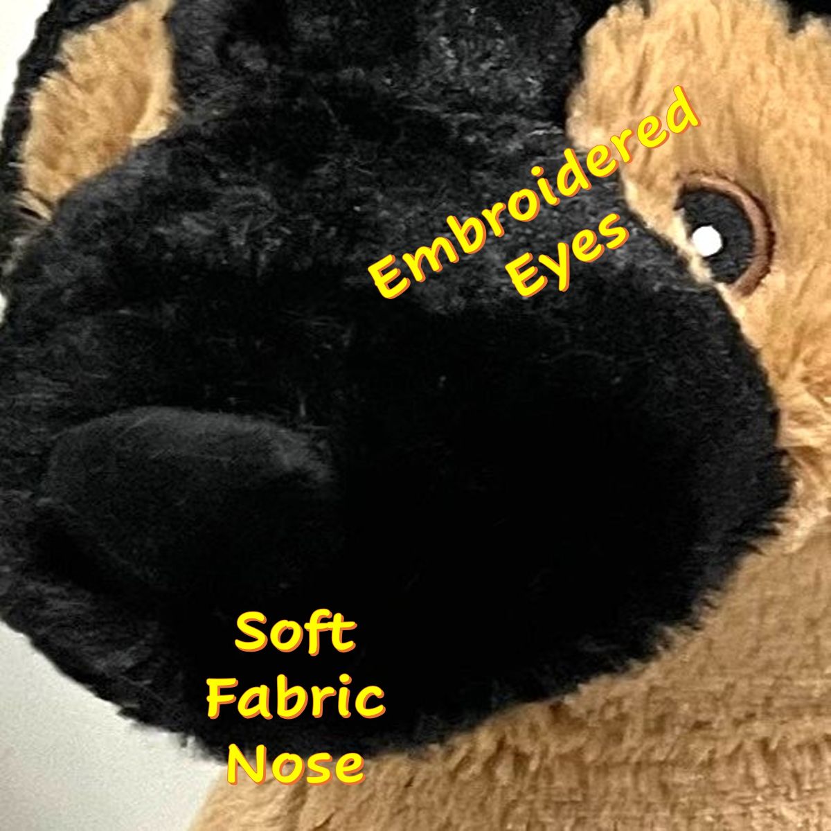 Close-up of a German Shepherd Plush Dog toy with black and tan fur, embroidered eyes, and a soft fabric nose.